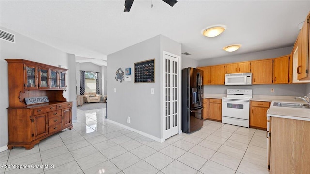 kitchen with ceiling fan, sink, white appliances, and light tile patterned floors