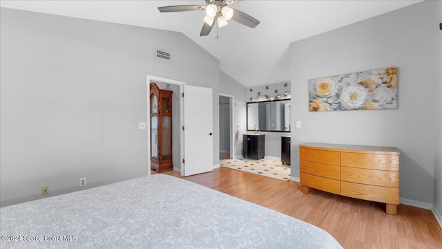 bedroom featuring ensuite bathroom, ceiling fan, light hardwood / wood-style flooring, and lofted ceiling