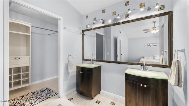 bathroom with tile patterned flooring, lofted ceiling, ceiling fan, and vanity