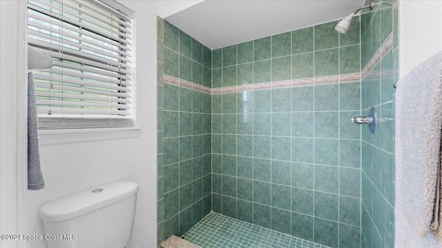 bathroom featuring toilet and tiled shower