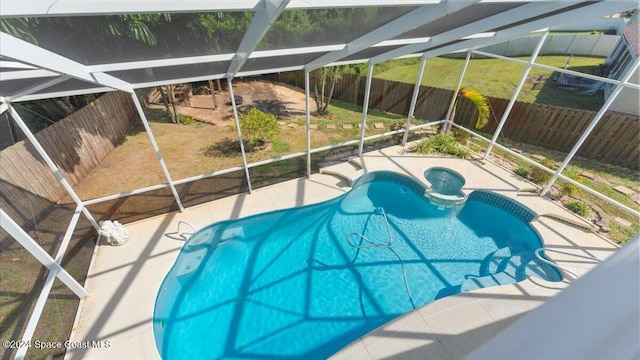 view of swimming pool with a lanai, a yard, and a patio area