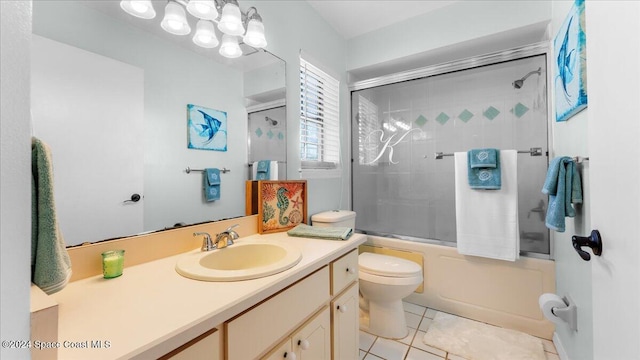 full bathroom featuring toilet, vanity, tile patterned flooring, and shower / bath combination with glass door