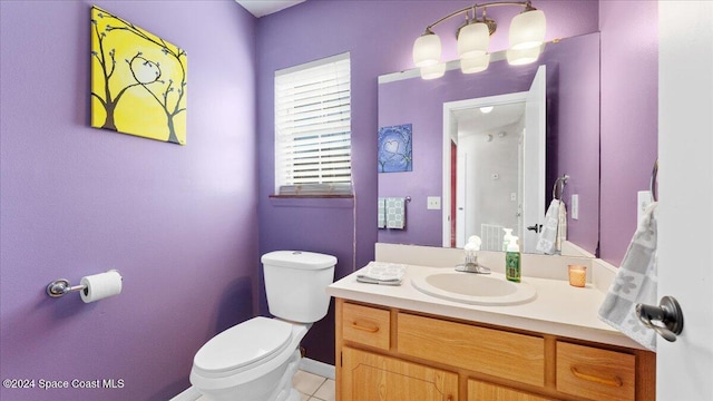 bathroom featuring toilet, vanity, and tile patterned flooring