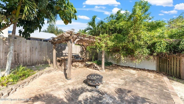 view of patio featuring a pergola and an outdoor fire pit