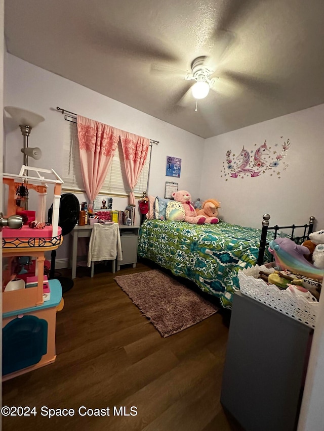 bedroom with ceiling fan and dark wood-type flooring