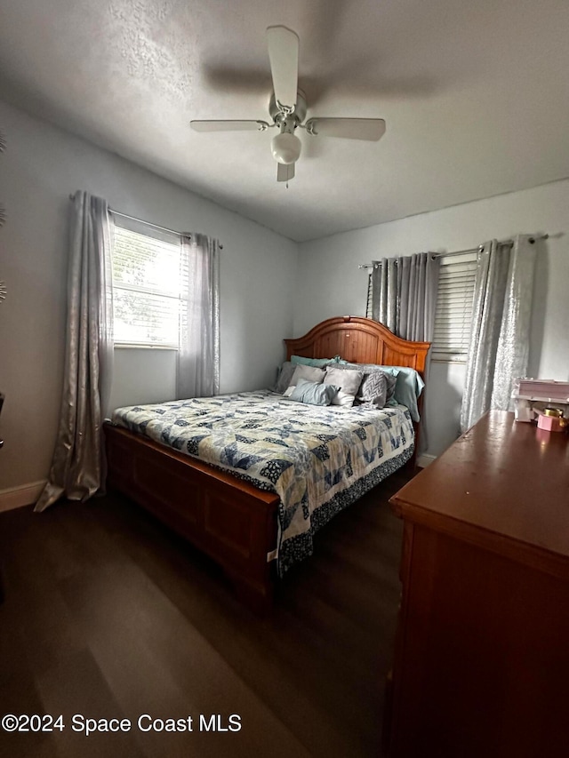 bedroom featuring ceiling fan and dark hardwood / wood-style flooring