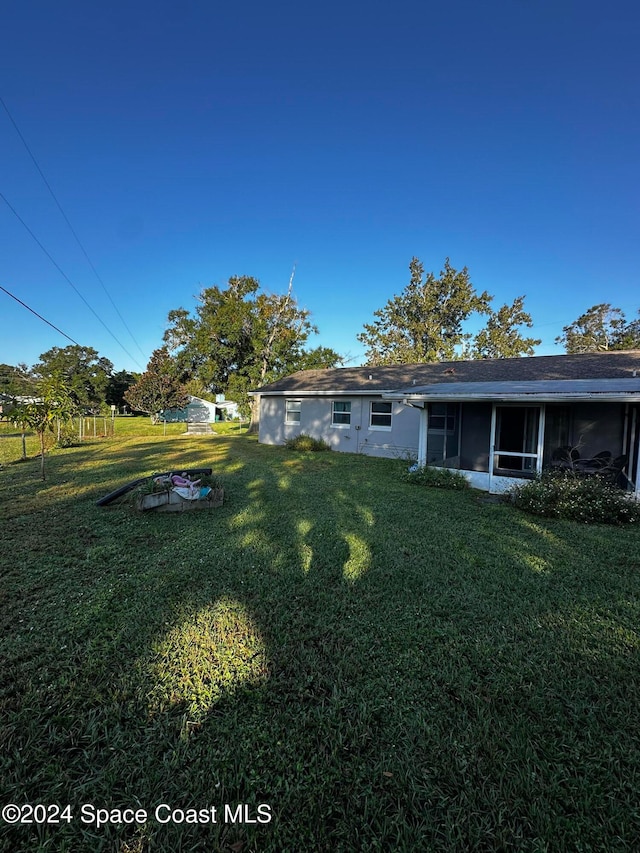 view of yard with a sunroom