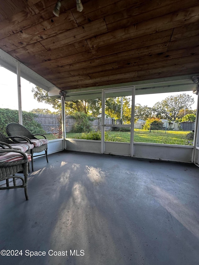 unfurnished sunroom featuring wooden ceiling