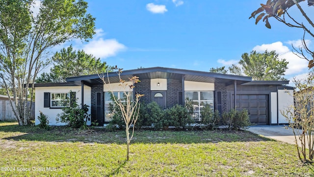 ranch-style home with a front lawn and a garage