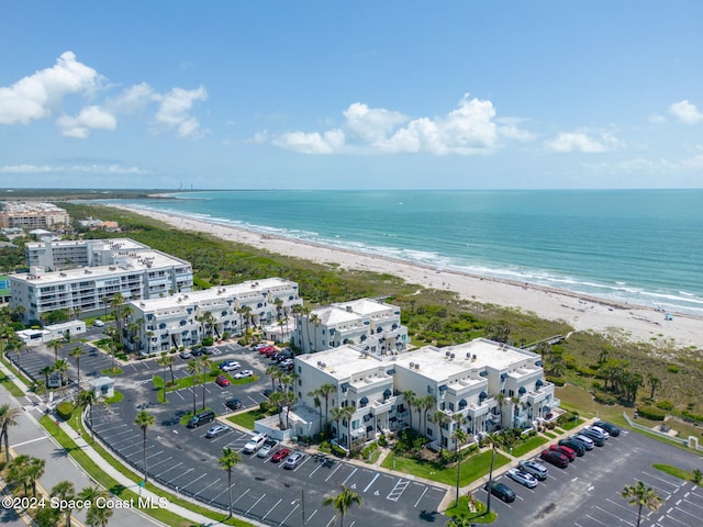 drone / aerial view featuring a water view and a beach view