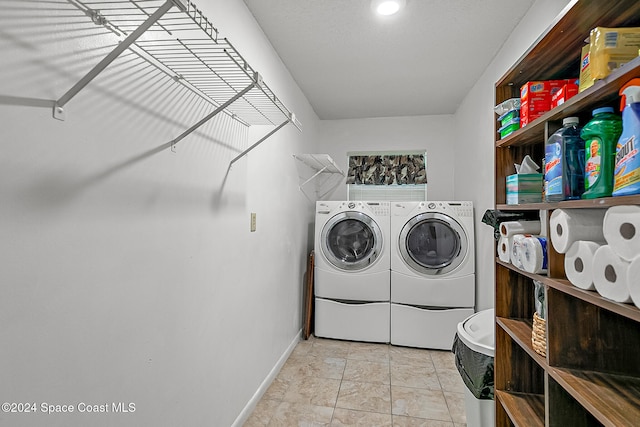 clothes washing area with washing machine and clothes dryer