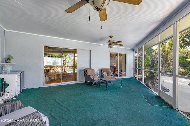 sunroom / solarium featuring ceiling fan