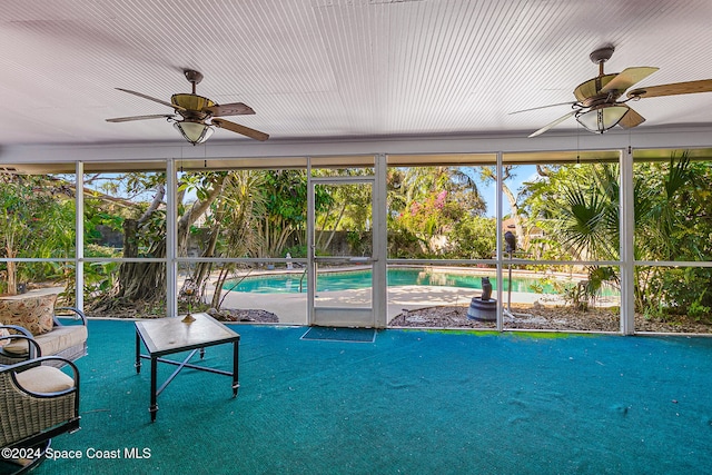 unfurnished sunroom featuring ceiling fan