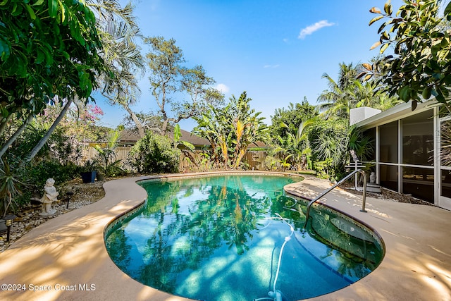 view of pool with a patio area and a sunroom