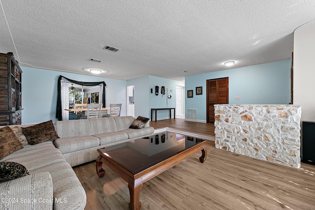 living room featuring hardwood / wood-style floors and a textured ceiling