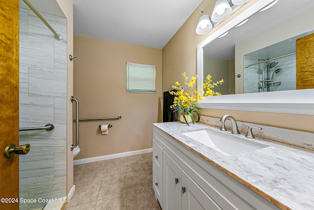 bathroom with tile patterned flooring, vanity, tiled shower, and toilet