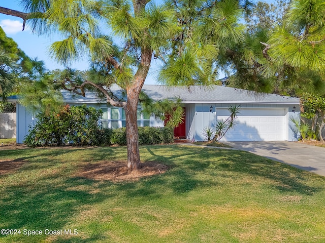 view of front of home featuring a garage and a front lawn