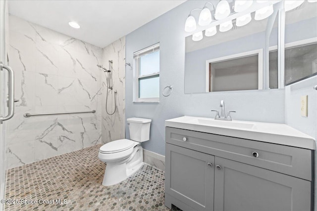 560 Rio Ln, Indialantic, FL 32903 - bathroom with a marble finish shower, toilet, vanity, baseboards, and tile patterned flooring