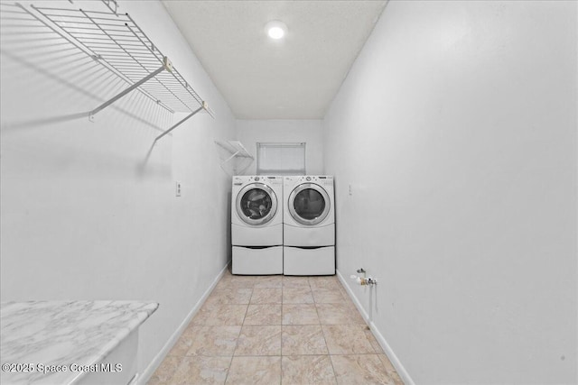 560 Rio Ln, Indialantic, FL 32903 - washroom featuring washing machine and clothes dryer and baseboards