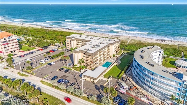 birds eye view of property featuring a beach view and a water view