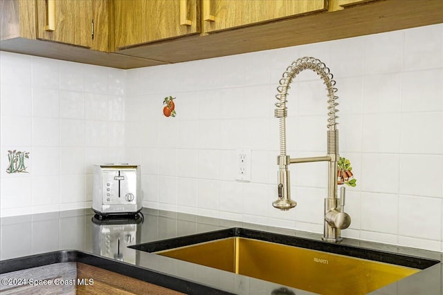 interior details featuring sink and backsplash