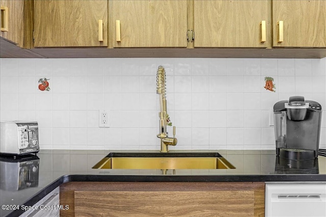 kitchen with sink, dishwasher, and tasteful backsplash