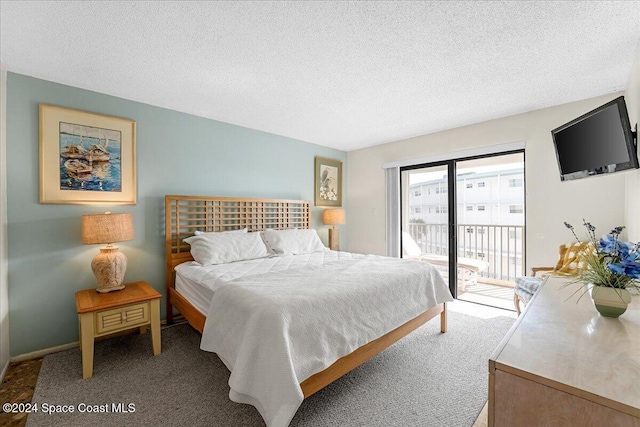 bedroom with a textured ceiling, carpet flooring, and access to exterior