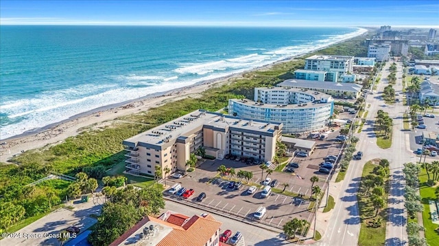 birds eye view of property featuring a beach view and a water view