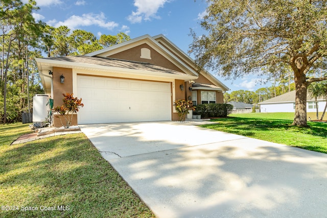 view of front of home featuring a front yard and a garage