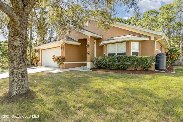 single story home featuring a front yard and a garage