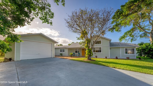 ranch-style house with a front yard and a garage