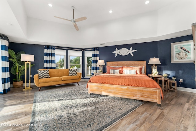 bedroom with hardwood / wood-style floors and ceiling fan