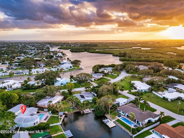 aerial view at dusk with a water view