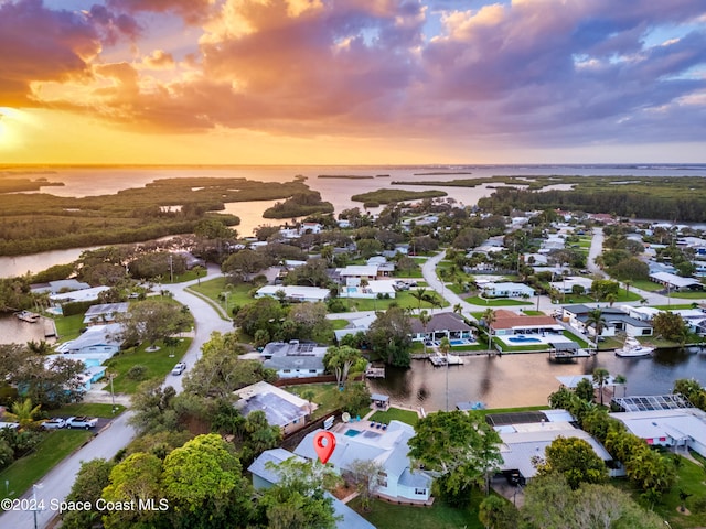 aerial view at dusk with a water view