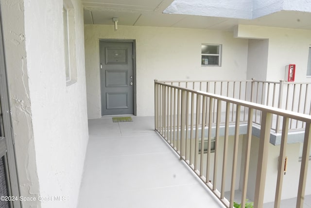 view of exterior entry featuring a balcony