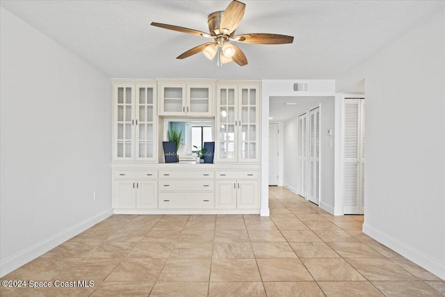 5800 N Banana River Blvd Unit 134, Cape Canaveral, FL 32920 - unfurnished room with visible vents, baseboards, light tile patterned flooring, a textured ceiling, and a ceiling fan