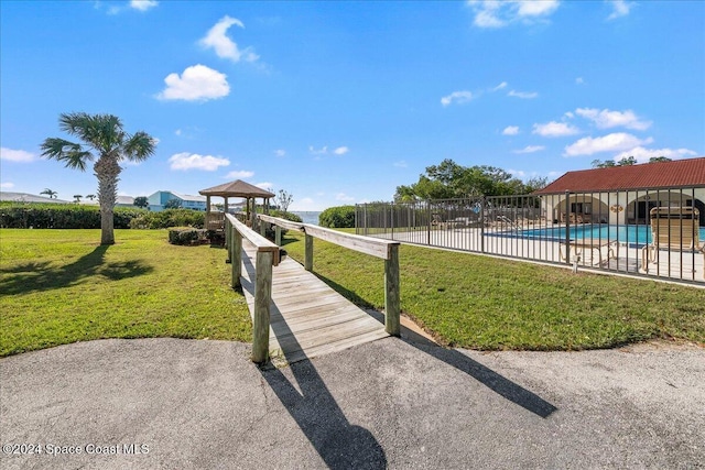 5800 N Banana River Blvd Unit 134, Cape Canaveral, FL 32920 - view of home's community featuring a swimming pool, a lawn, a gazebo, and fence