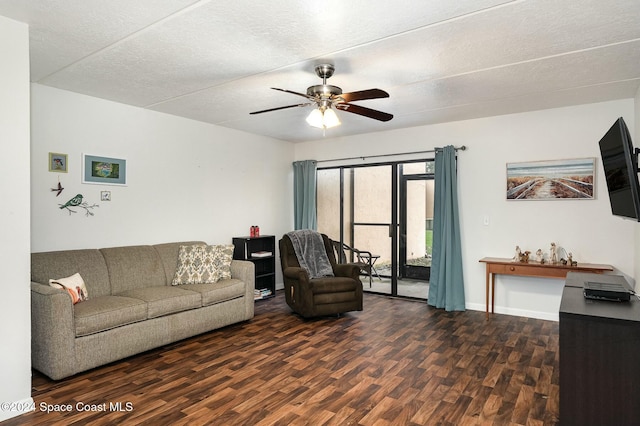 living room with dark hardwood / wood-style floors, ceiling fan, a textured ceiling, and french doors