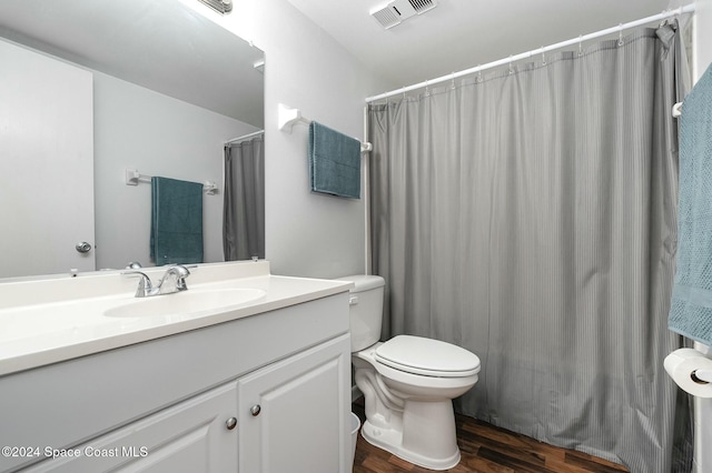 bathroom with vanity, wood-type flooring, and toilet