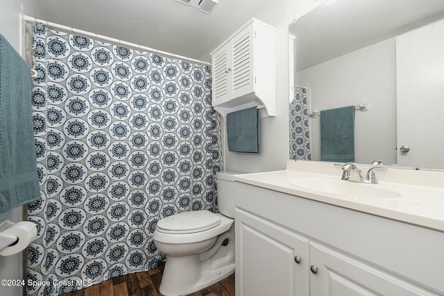 bathroom featuring hardwood / wood-style floors, vanity, and toilet