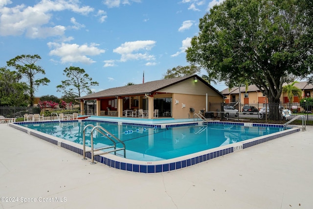 view of swimming pool with a patio area