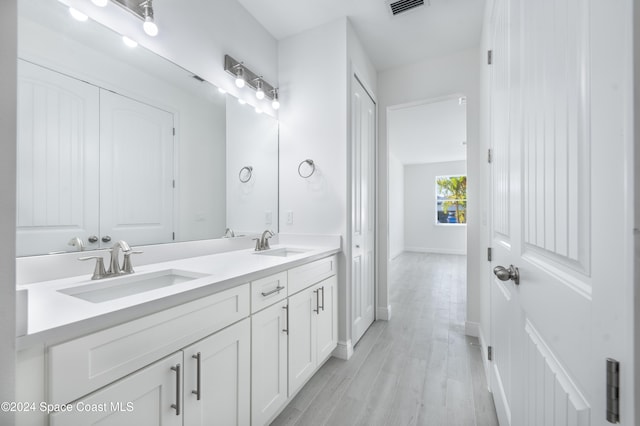 bathroom featuring hardwood / wood-style flooring and vanity