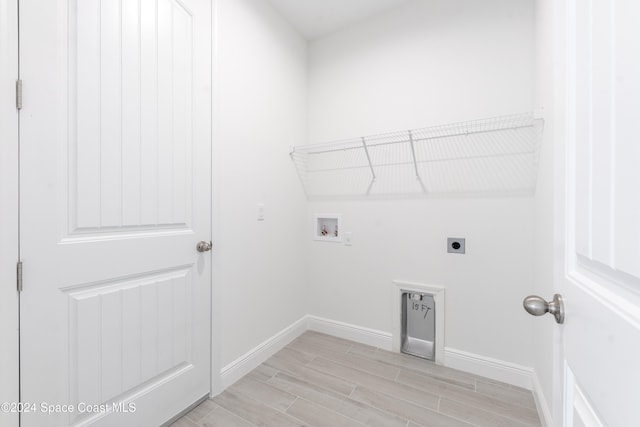 washroom with hookup for an electric dryer, light wood-type flooring, and washer hookup