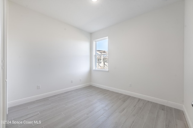 empty room with light hardwood / wood-style flooring