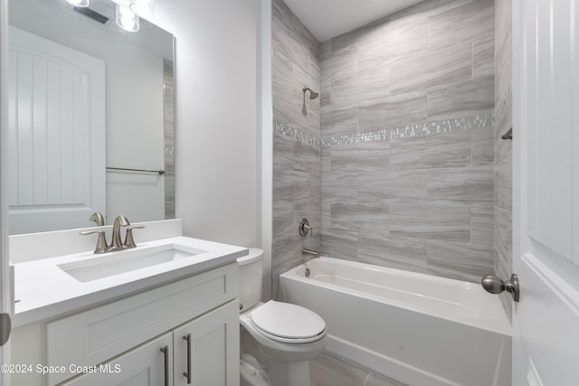 full bathroom with tiled shower / bath, toilet, and vanity