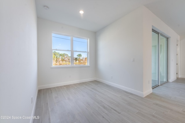 empty room with light hardwood / wood-style flooring