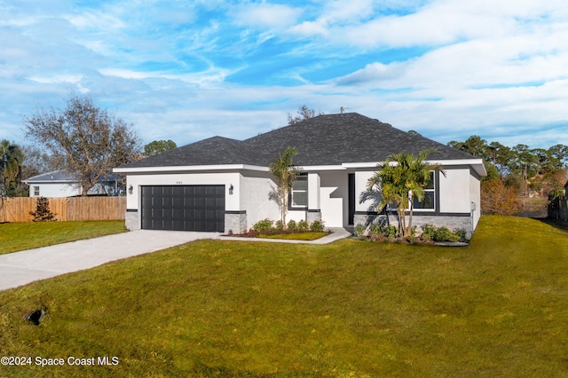 ranch-style home with a garage and a front lawn