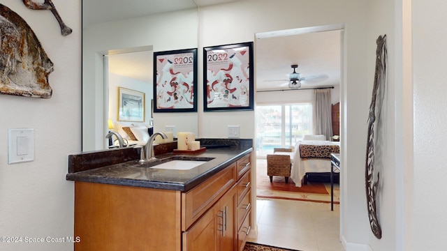 interior space with vanity, tile patterned floors, and ceiling fan