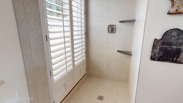 bathroom with a tile shower