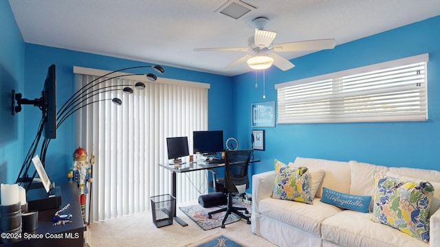 carpeted office featuring ceiling fan